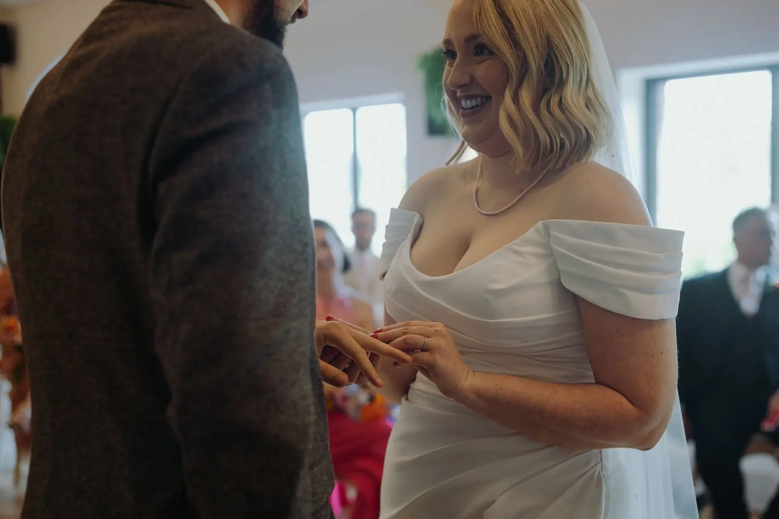 Bride looking down as the ring goes on