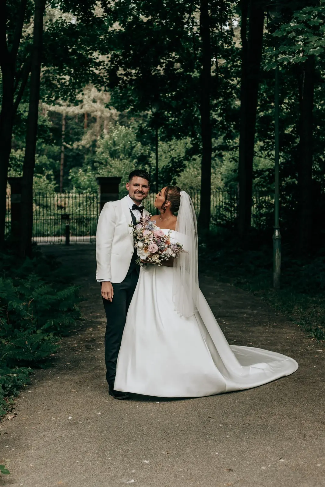Couple kissing on a woodland path