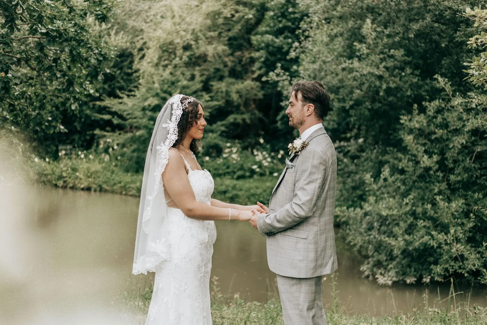 Couple holding hands beside the lake