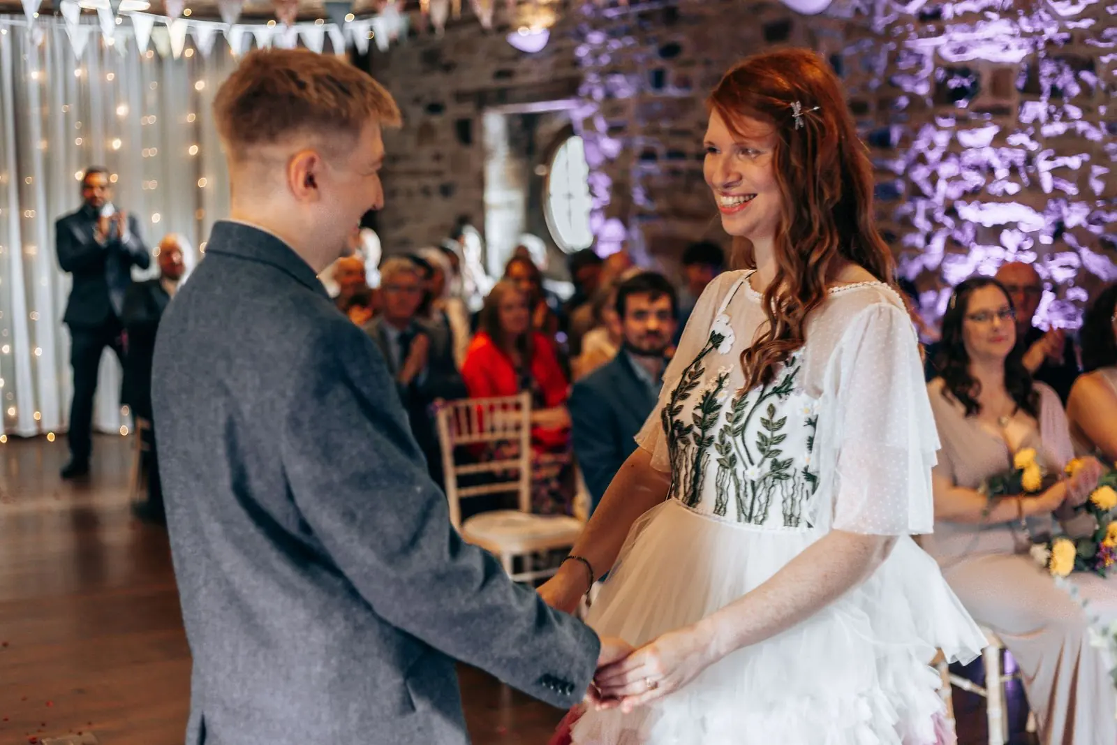 Couple holding hands during the vows