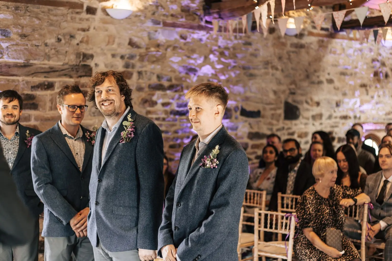 Groom and groomsmen waiting at the ceremony under bunting